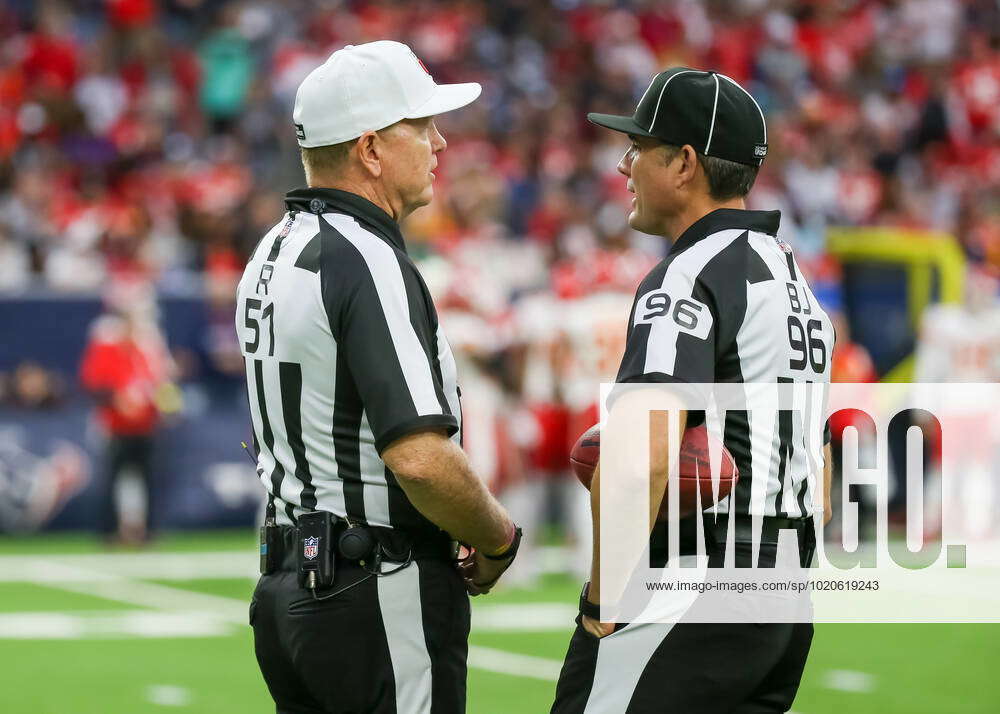 HOUSTON, TX - DECEMBER 18: (left to right) Referee Carl Cheffers (51) chats  with back judge Matt