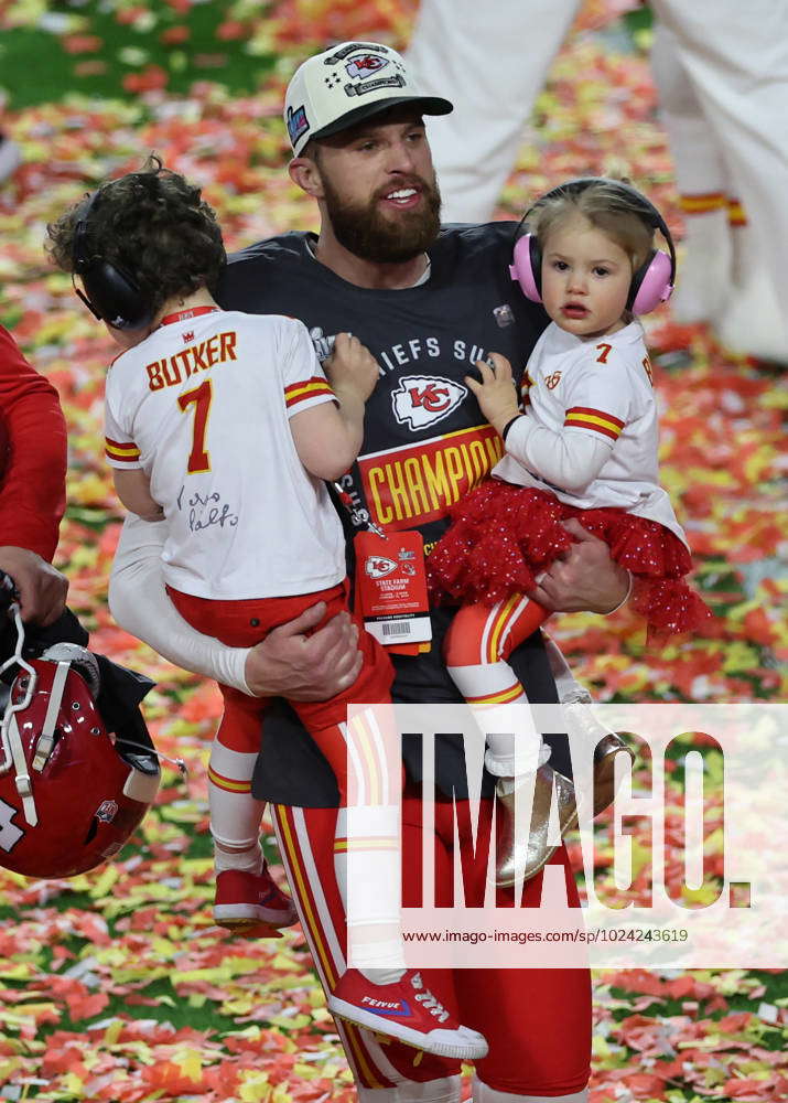 Kansas City Chiefs place kicker Harrison Butker (7) holds his children