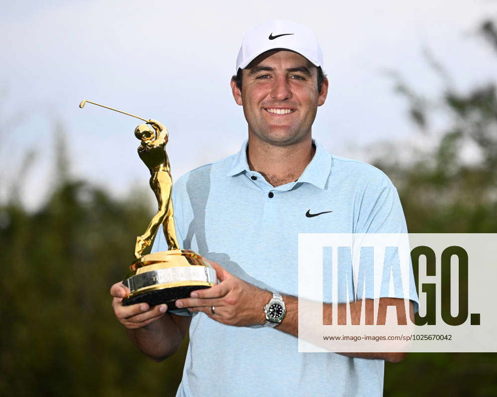 Scottie Scheffler holds his trophy after winning the competition at The