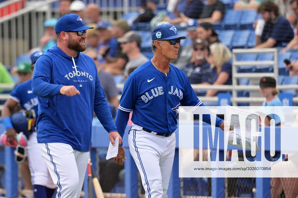 Toronto Blue Jays manager John Schneider (L) and bench coach Don Mattingly  walk to the dugout