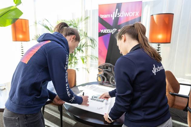 Belgian Lotte Kopecky of SD Worx signs an autograph during a press