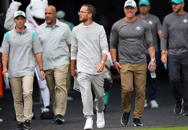 Syndication: Palm Beach Post Miami Dolphins head coach Mike McDaniel,  center, takes the field for