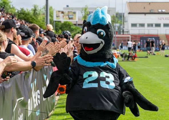 Mascot Dave the Rave Munich Ravens high-fiving Robert Werner Munich ...
