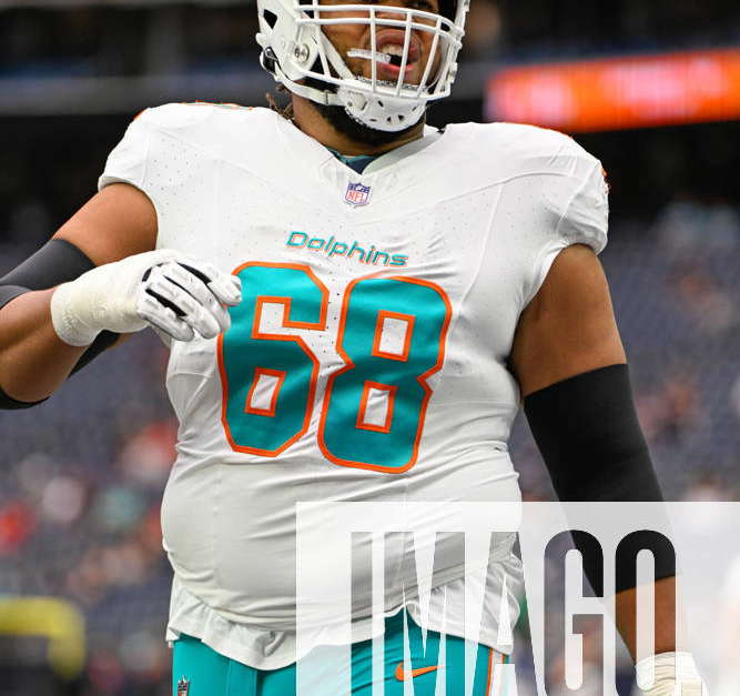 Miami Dolphins offensive lineman Robert Hunt (68) raises his arms as he is  introduced to the fans and runs onto the field before an NFL football game  between the Houston Texans and