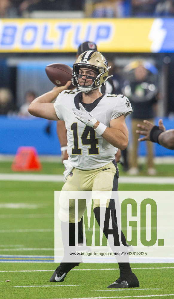 New Orleans Saints quarterback Jake Haener (14) runs through