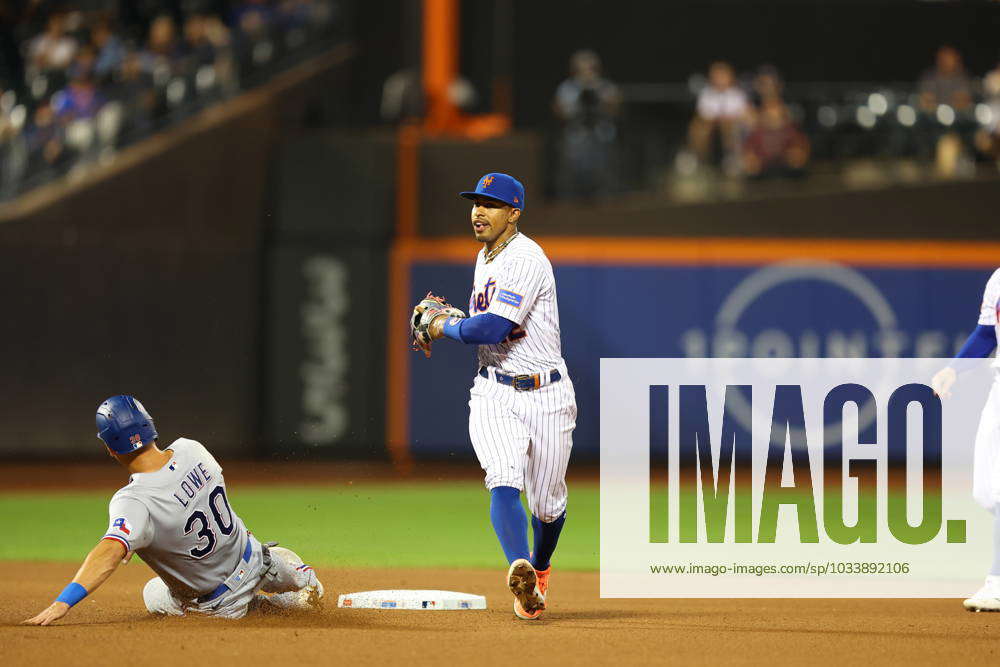 New York Mets Shortstop Francisco Lindor turns a double play on a