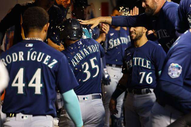 Seattle Mariners Vs. New York Mets Seattle Mariners Teoscar Hernandez 35 is  handed the trident after