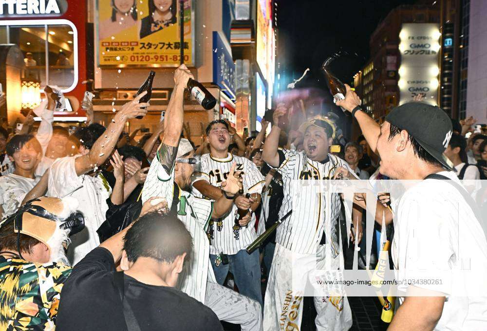 Fans of Hanshin Tigers celebrate as the team clinched their first