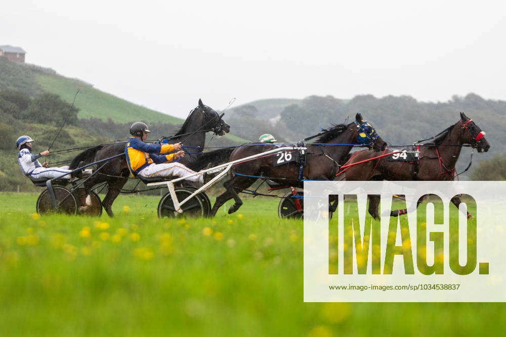 Through the rain, muddy faced jockeys and their horses took part in the ...