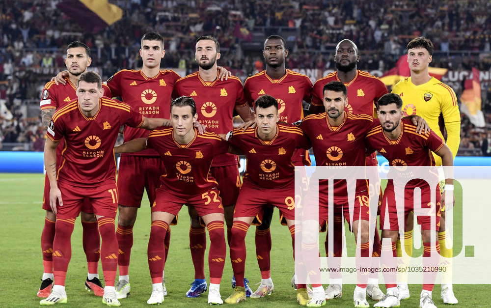 AS Roma players pose for a team photo wearing the shirt with the new