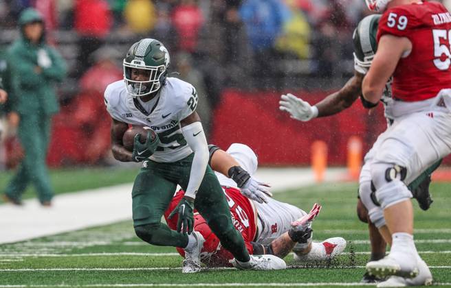 Chance Rucker : Michigan State Spartans defensive lineman Derrick Harmon grabs a hold ...