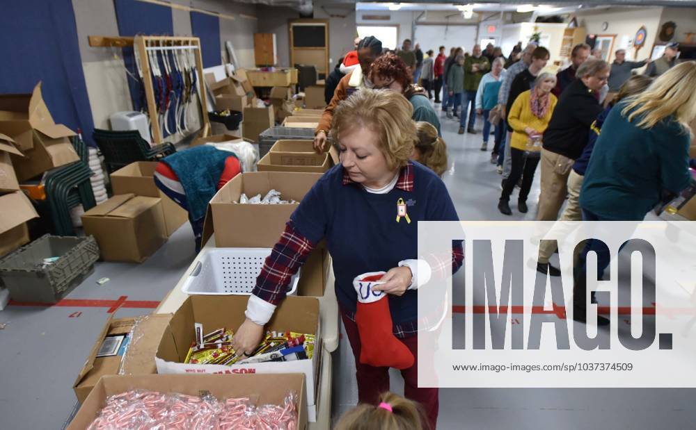 Syndication Cape Cod Times BOURNE 11 25 23 Kate McCoy fills a stocking