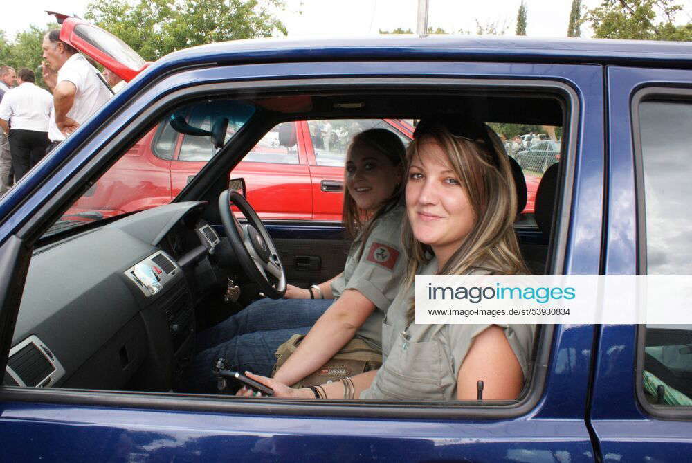 Two young women proudly wearing the swastika logo of the Afrikaner