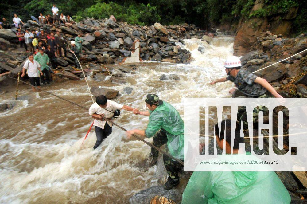 XINXIANG, Aug. 20, 2010 Rescuers help a tourist cross a riptide at ...