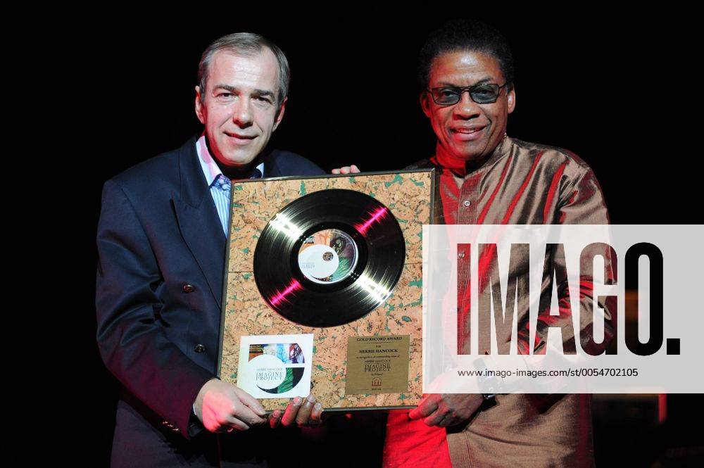 Herbie Hancock (R) receives a gold record during his concert Deutsche Bank Invites Herbie Hancock