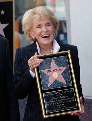 Singer Jane Morgan holds a replica plaque as she is honored with the 2 ...