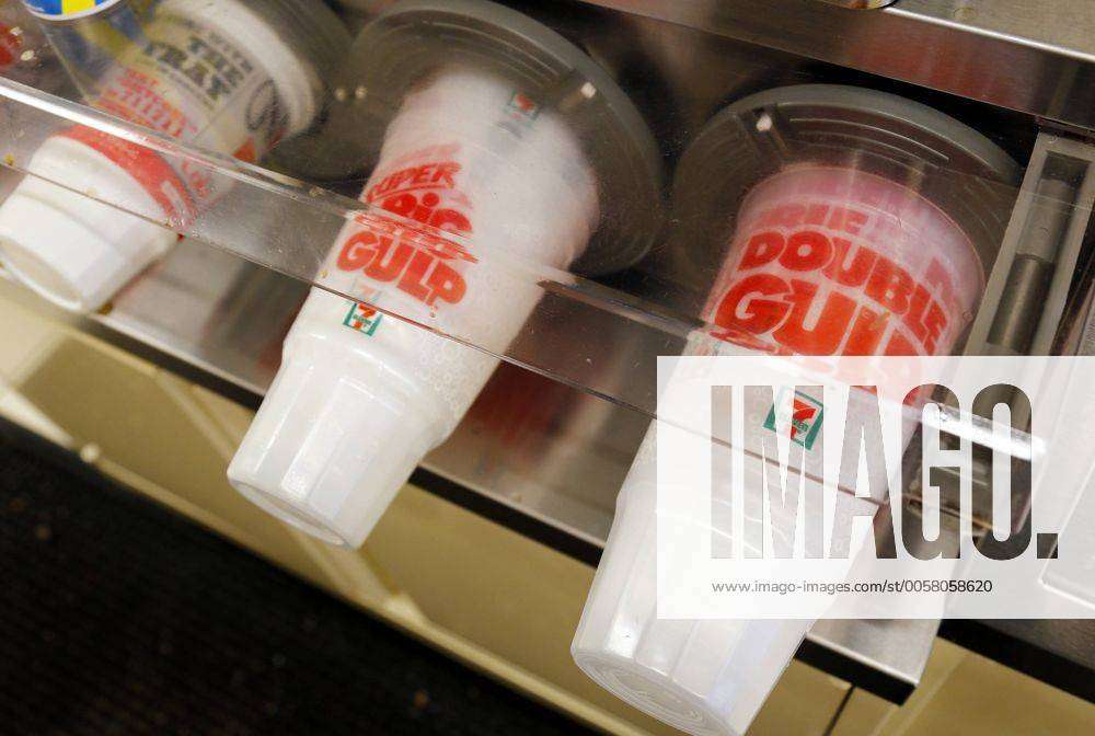 Big Gulp giant soda cups are arranged in size order in a store on