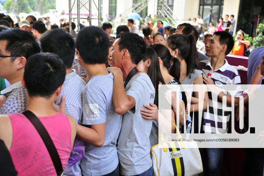 WENLING, CHINA - JULY 04: (CHINA OUT) People queue to buy house at a ...