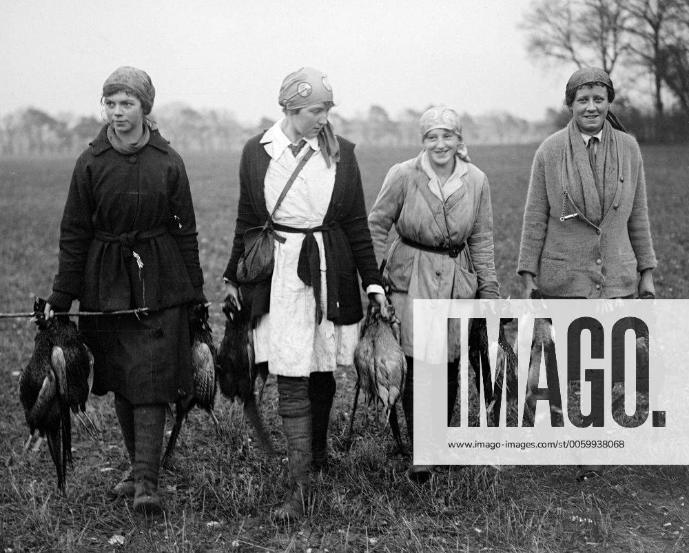 Girl beaters on a country estate in Norfolk carrying the shot game birds to the farm cart