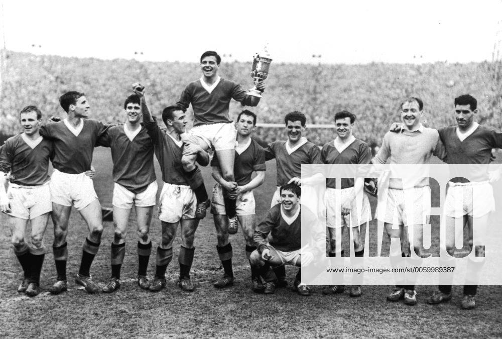 The Glasgow Rangers team are shown sporting the trophy which they won ...