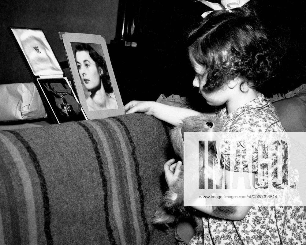 Tania Szabo, looking at the picture of her mother Violette Szabo and the Cross (awarded to