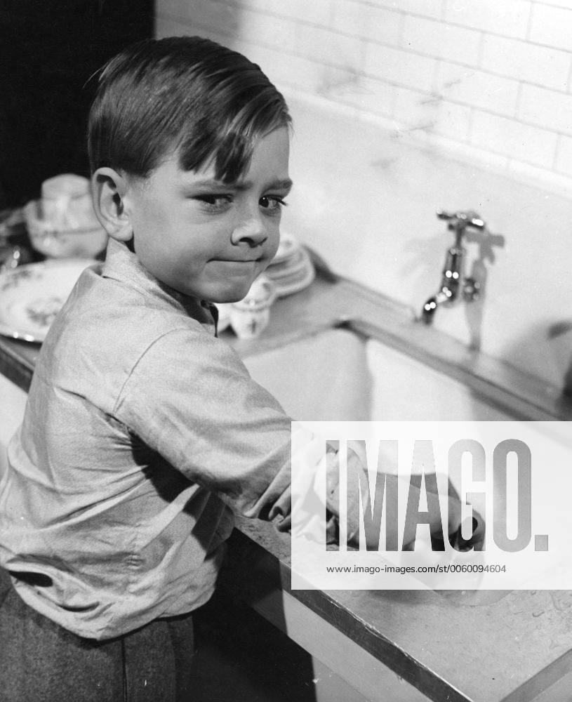 Child at sink, washing up. UnitedArchives