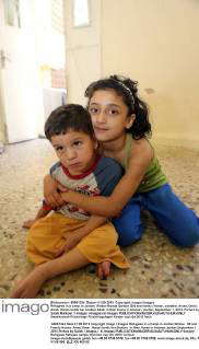 Refugees in a camp in Jordan. Widow Rawda Qanbar (29) and family: Hanan ...