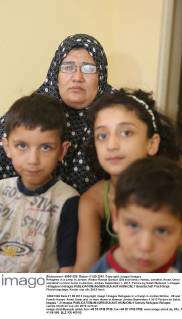 Refugees in a camp in Jordan. Widow Rawda Qanbar (29) and family: Hanan ...