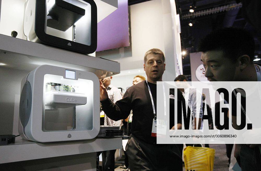 An exhibitor operates a 3D printer at the 2014 International CES, on