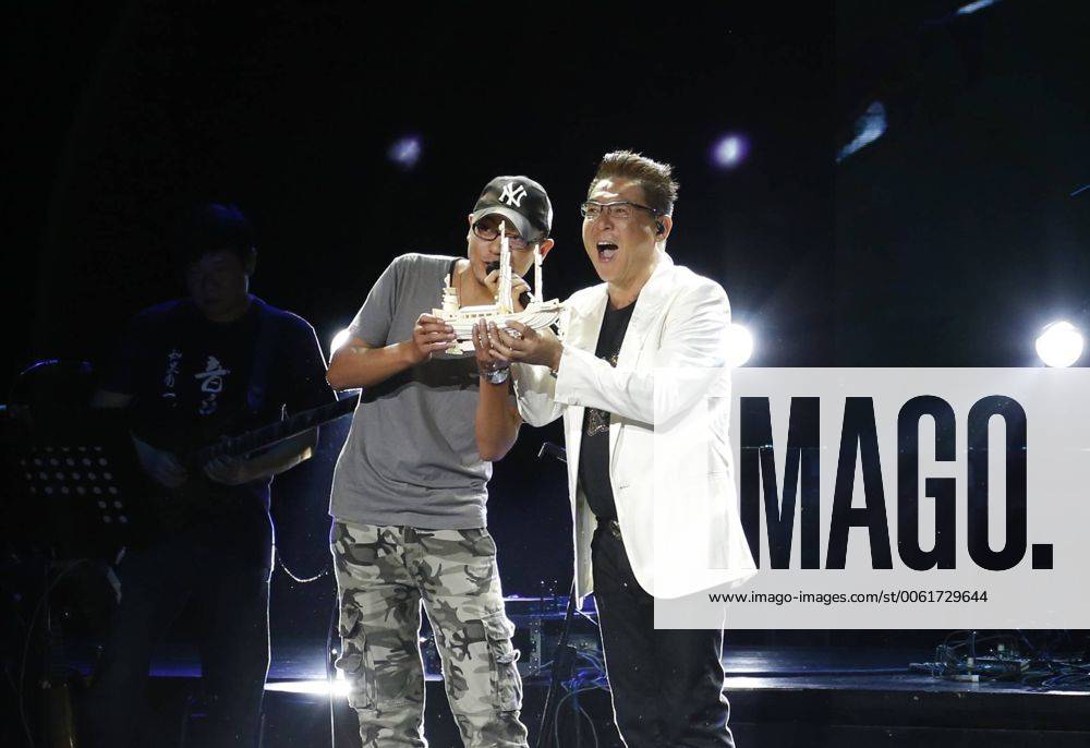 Singer Johnny receives a gift from his fan during his solo concert in ...