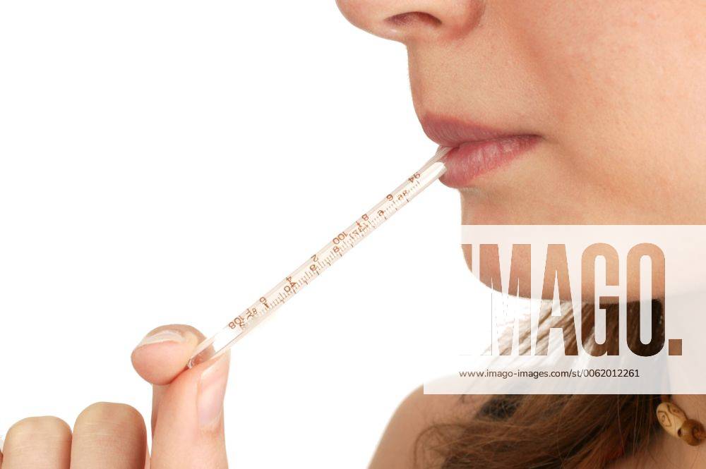 A woman with a mercury thermometer in her mouth. She is taking her own