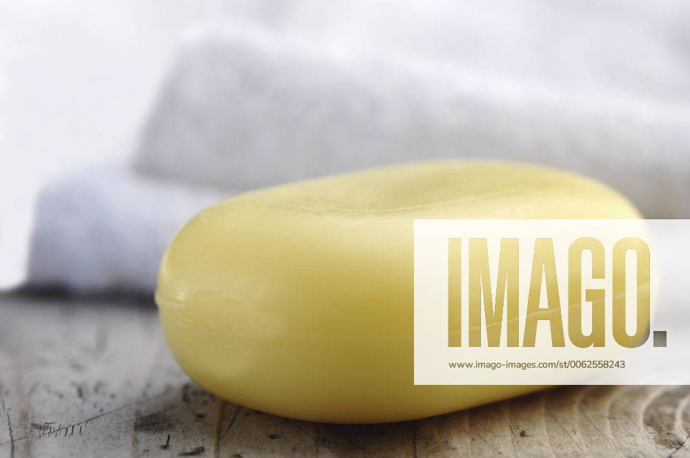 Bar of soap with towel on wooden table