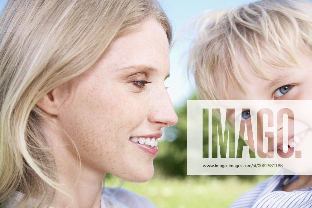 Germany, Cologne, Mother and son smiling, close up model released Y