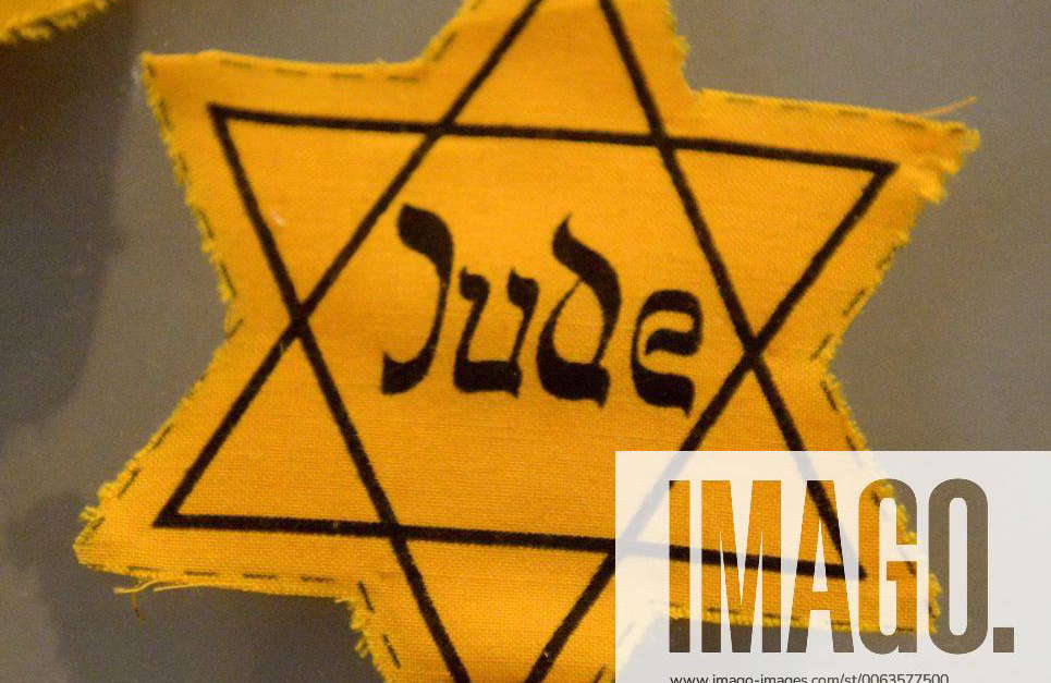 A yellow star worn by Jews during the reign of Nazi Germany in War ...