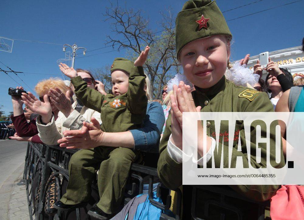 SEVASTOPOL, CRIMEA, RUSSIA. MAY 7, 2015. Girls in Soviet uniform watch ...