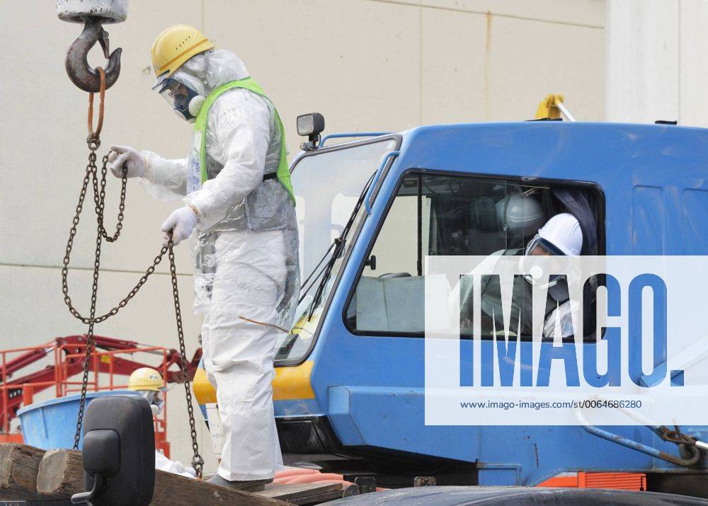 Workers in radiationproof suits at Fukushima nuclear plant Workers