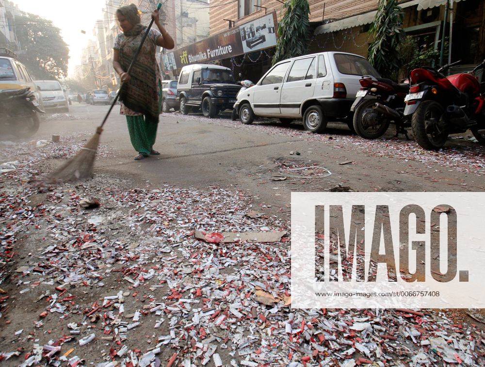 NEW DELHI, INDIA - NOVEMBER 12: MCD workers clean a street littered ...