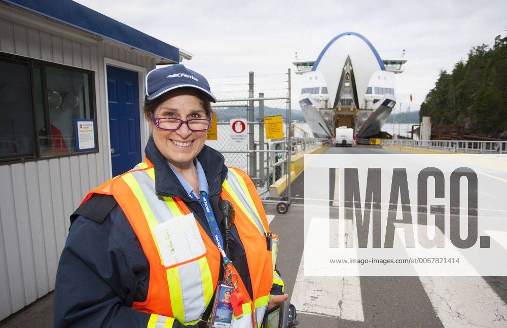 A BC Ferry employee prepares to board traffic aboard the Queen of the ...