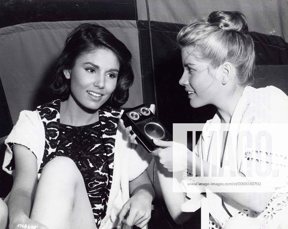 PAULA PRENTISS with Dolores Hart with a tiny radio between scenes of ...