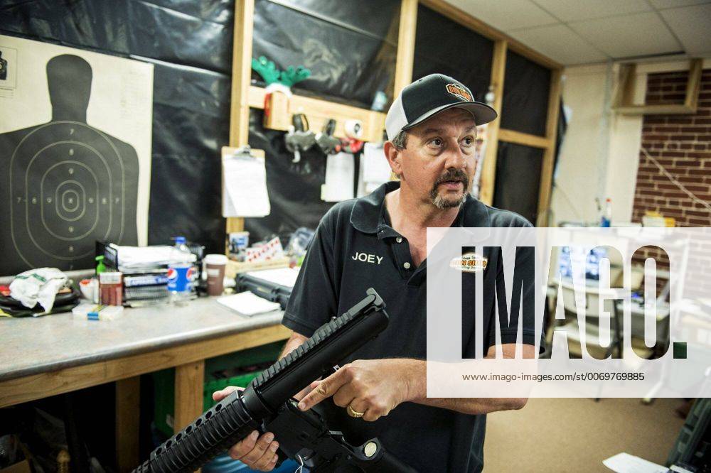 March 3, 2016 - Joey Verna, owner of Stage Stop Gun Shop, holds an AR ...