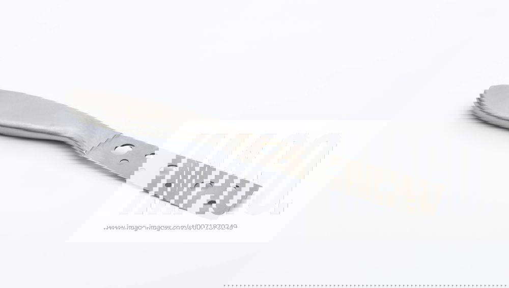 Cheese knife with holes in the blade, designed for slicing soft cheese