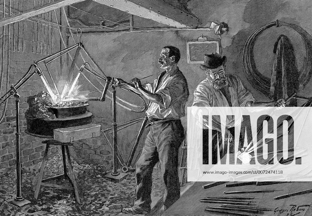 Welding a bicycle frame France. Frame suspended over and