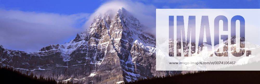 Canada, Alberta, Mt. Chephren. Mount Chephren wears a mantle of clouds ...