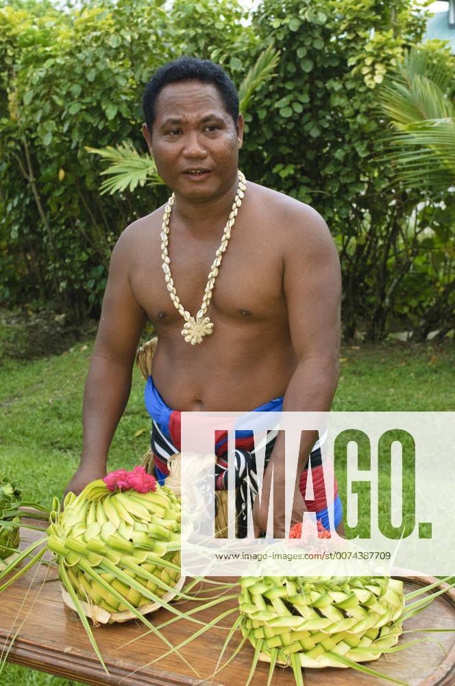 Yap. Yapese chief with woven food baskets