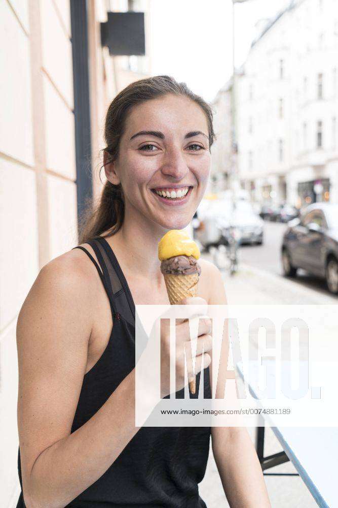 Portrait of happy young woman with ice cream cone model released Symbolfoto