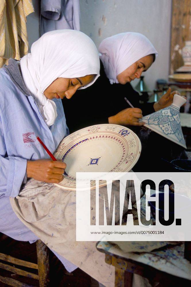 Women painting pottery, potters village of Safi, Atlantic coast ...