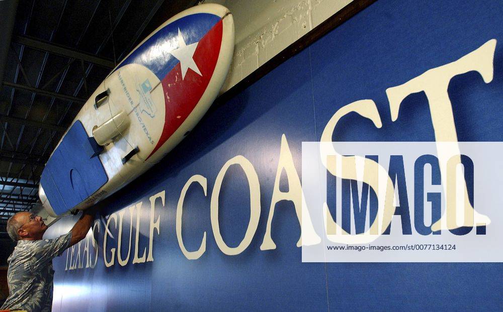 May 29, 2005; San Antonio, TX, USA; Danny Jauer hangs a display surfboard at the new Texas Surf