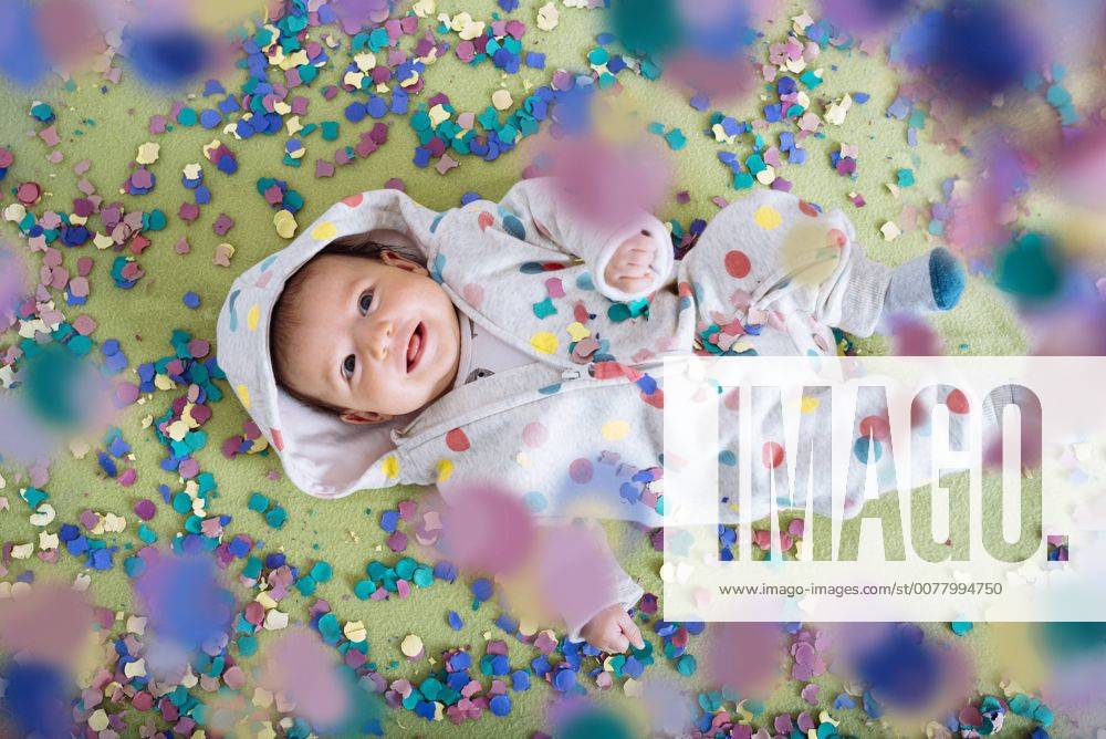 Happy baby girl surrounded by confetti model released Symbolfoto Y