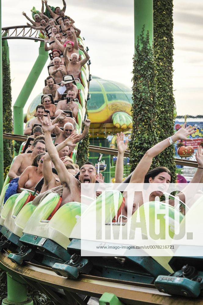 Naked thrill seekers ride the Green Scream roller coaster on a