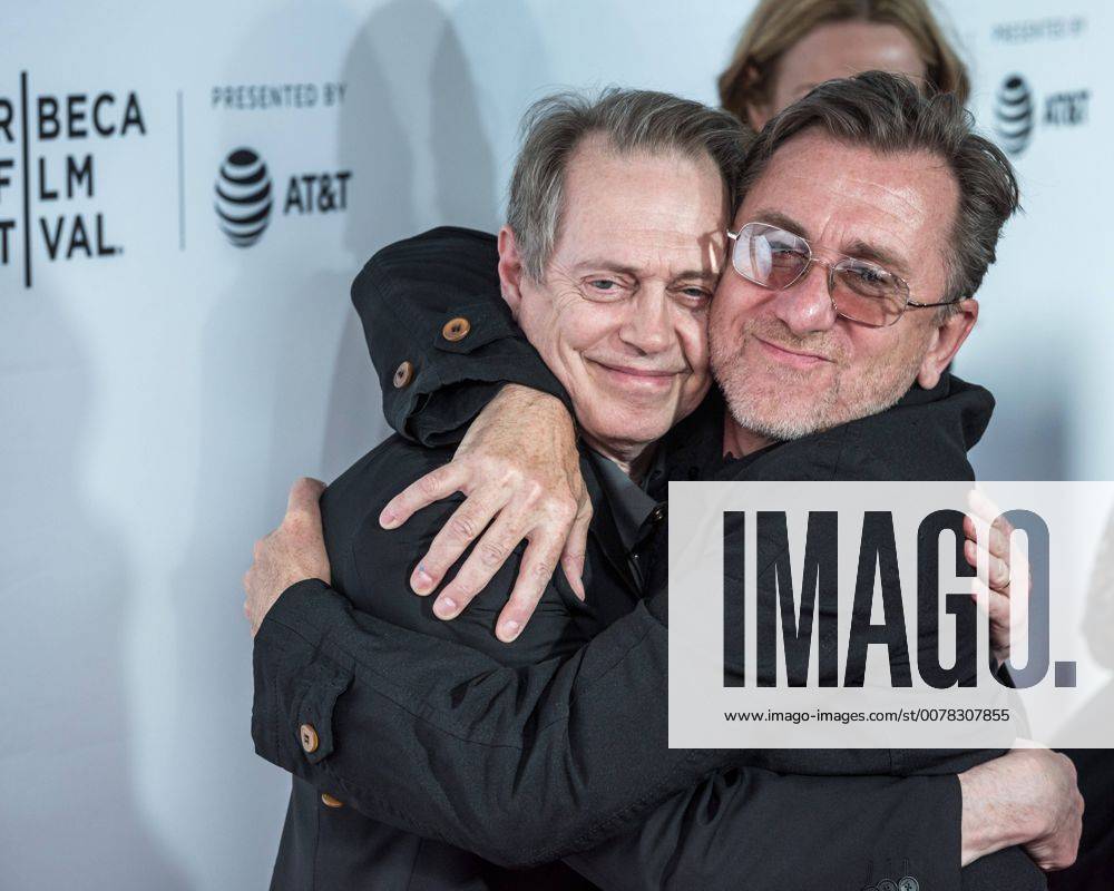 Actors Steve Buscemi L and Tim Roth embrace each other as they